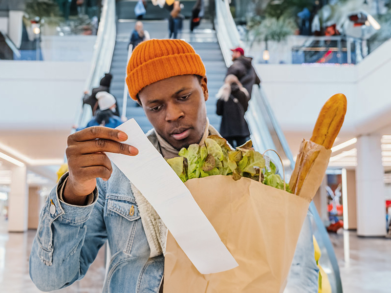 Man looking at his grocery receipt