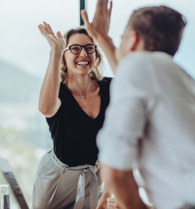 Team high-fiving in office