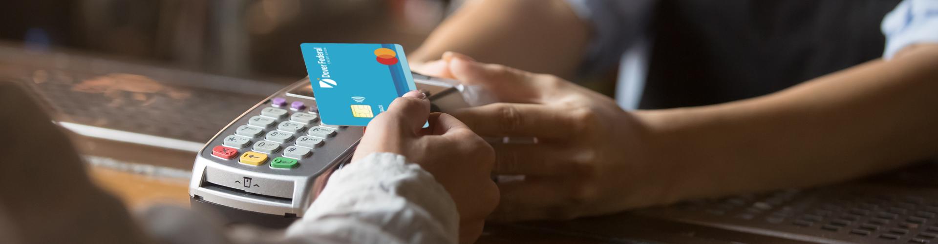 Woman uses her Dover Federal Credit Union Cash Back Mastercard