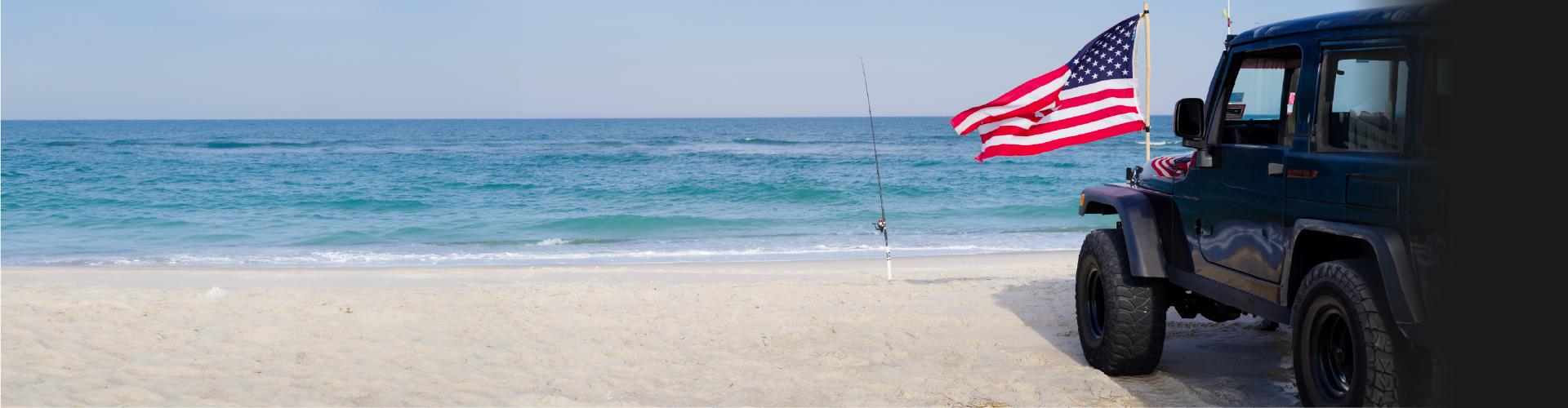 Jeep on beach with American flag
